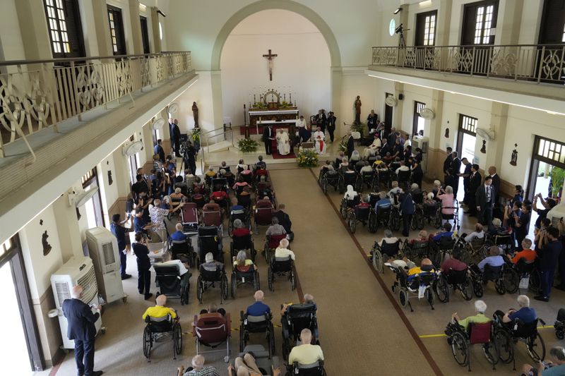 Pope Francis meets with a group of elderly and sick people at the St. Theresa's Home in Singapore, Friday, Sept. 13, 2024. Pope Francis is wrapping up his visit to Singapore by praising its tradition of interfaith harmony. (AP Photo/Gregorio Borgia)