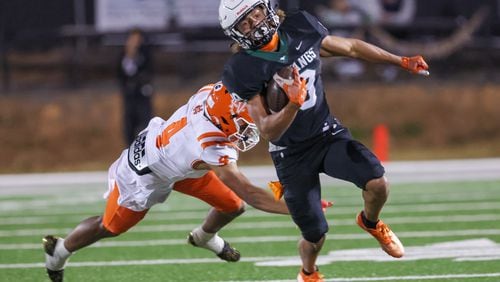 Kennesaw wide receiver Cayden Lee (19) evades North Cobb defensive back Jordan Lonas (4) n the second half of the North Cobb versus Kennesaw Mountain high school football game at Kennesaw on Friday, October 21, 2022. North Cobb won 22-19. (Arvin Temkar / arvin.temkar@ajc.com)