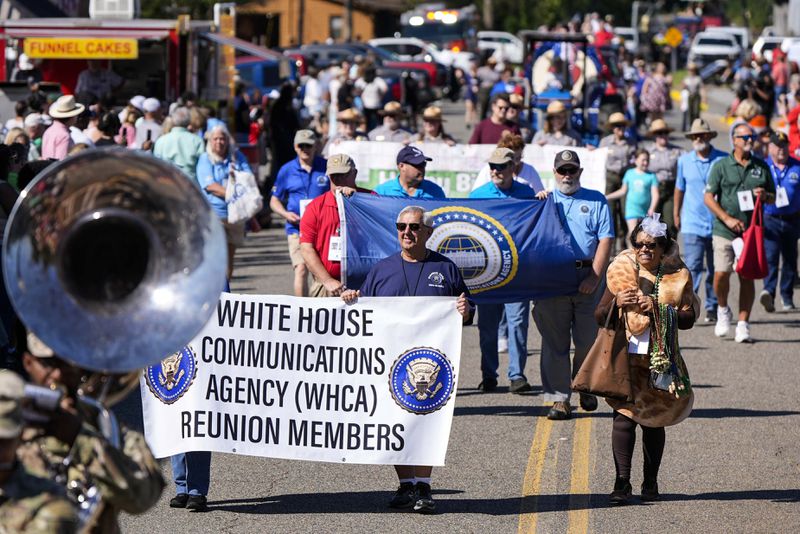 The parade moves down main street during the 26th annual Plains Peanut Festival, ahead of former President Jimmy Carter's birthday on Oct. 1, Saturday, Sept. 28, 2024, in Plains, Ga. Carter didn't attend the festival. (AP Photo/Mike Stewart)