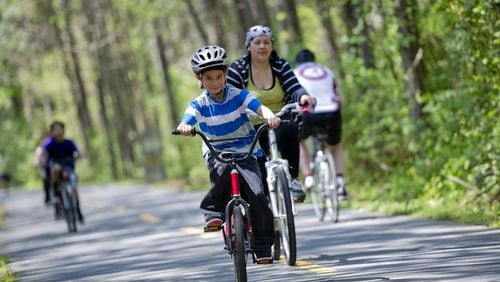 Families and Lycra-clad bike enthusiasts alike enjoy the Silver Comet Trail, which starts in Smyrna and connects with the Chief Ladiga Trail near the Alabama line. AJC Staff