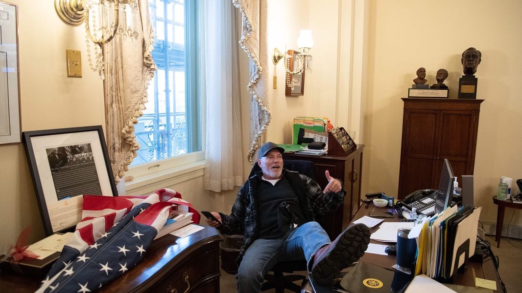 A supporter of President Donald Trump sits in the office of Speaker of the House Nancy Pelosi as he protests inside the U.S. Capitol in Washington, D.C., on January 6, 2021. (Saul Loeb/AFP/Getty Images/TNS)