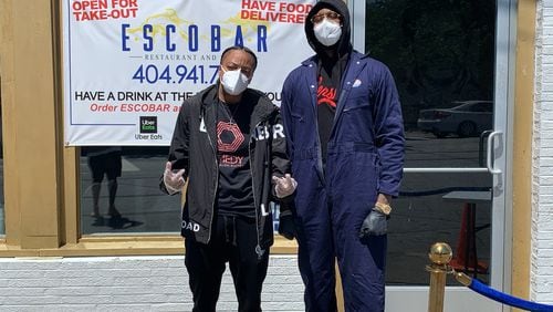 Co-owners of Escobar Lounge Mychel "Snoop" Dillard (left) and rapper 2Chainz personally helped serve meals to the homeless after deciding not to reopen their restaurant on April 27. COURTESY OF ESCOBAR LOUNGE