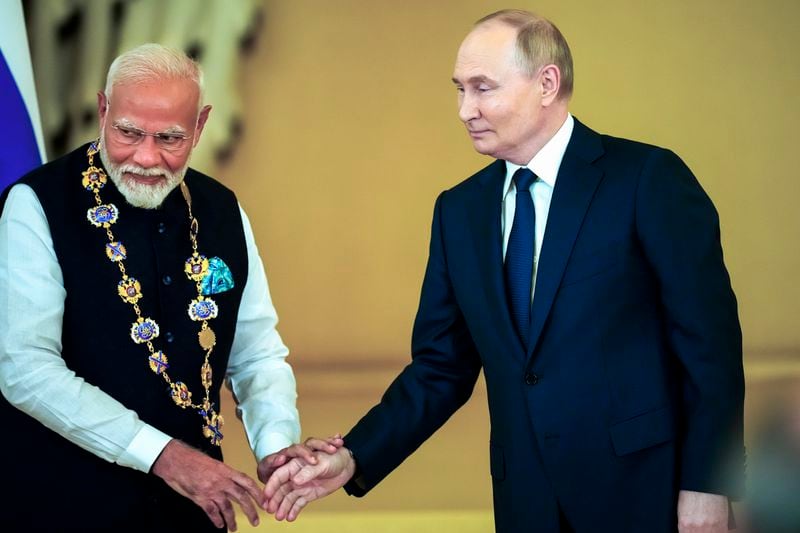 Russian President Vladimir Putin, right, shakes hands with Indian Prime Minister Narendra Modi after awarding him with the Order of St. Andrew the Apostle the First-Called at the Kremlin in Moscow, Russia, Tuesday, July 9, 2024. (AP Photo/Alexander Zemlianichenko)
