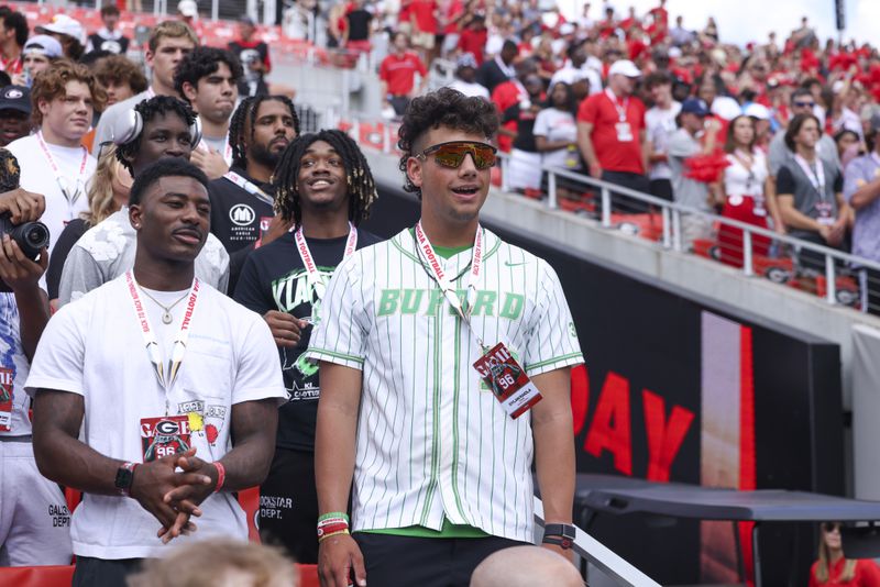 Buford quarterback Dylan Raiola, center, talks with Cass wide receiver Sacovie White, left, as they visit Georgia during their game against Ball State at Sanford Stadium, Saturday, September 9, 2023, in Athens, Ga. Georgia won 45-3. (Jason Getz / Jason.Getz@ajc.com)