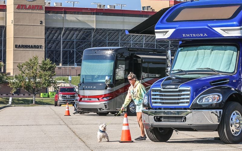 Hurricane Milton evacuee Paula Williams walks her dog at Atlanta Motor Speedway on Tuesday after fleeing their home in Clermont, Florida.