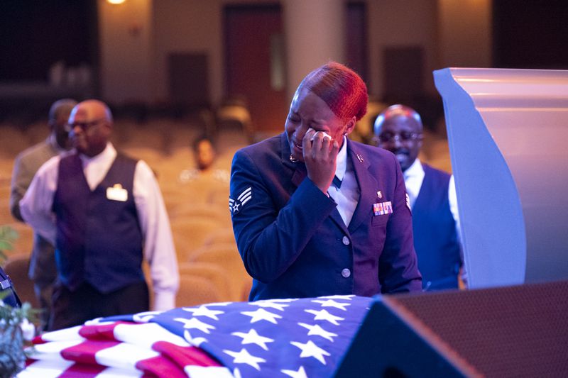 A member of the Air Force dries a tear while viewing Roger Fortson before the start of his funeral Friday.