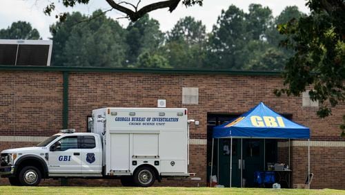 Georgia Bureau of Investigation staff move through an entrance to Apalachee High School after Wednesday's shooting, Thursday, Sept. 5, 2024, in Winder, Ga. (AP Photo/Mike Stewart)