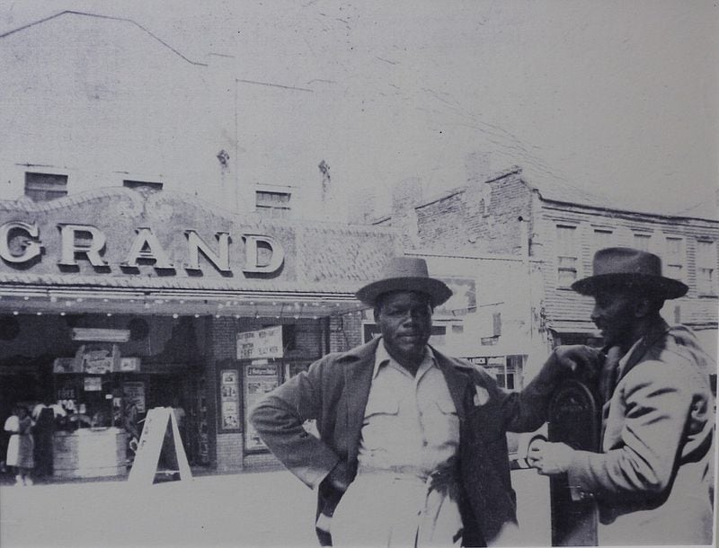 Two unknown jitney cab drivers pose for a photo in the late 1950s/'60s in front of the Grand Theatre on Chattanooga's Ninth Street. (Contributed photo provided by the Chattanooga Times Free Press)