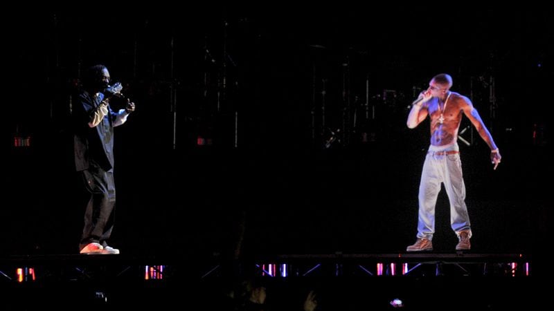 Rapper Snoop Dogg with a holographic image of Tupac Shakur is seen performing during day 3 of the 2012 Coachella Valley Music & Arts Festival at the Empire Polo Field on April 15, 2012 in Indio, California.
