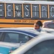 A bus outside Apalachee High School in Winder, Ga., as classes resumed after a Sept. 4 shooting there left four people dead. (John Spink/The Atlanta Journal-Constitution)