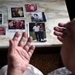 Suzy Patton shows old photos of her brother Steve Szarewicz, who insists he was wrongly convicted of a 1981 murder based on the testimony of four jailhouse informants on Tuesday, April 30, 2024 in her home in New Kensington, Pa. (AP Photo/Gene J. Puskar)