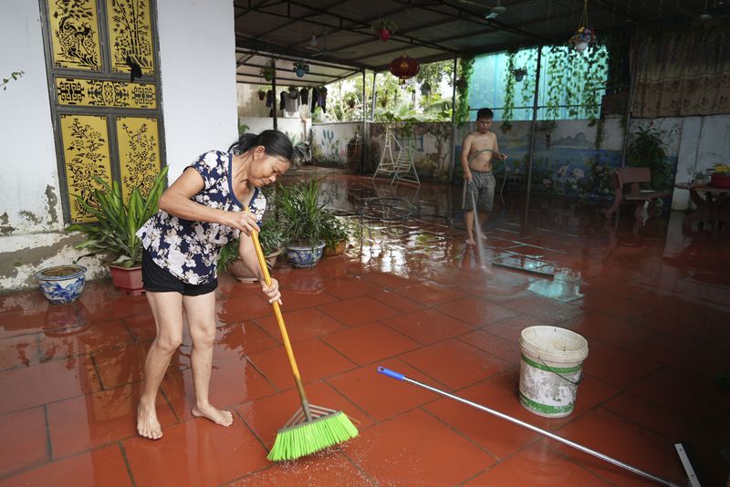 People clean their house after flood recedes in the aftermath of Typhoon Yagi in An Lac village, Hanoi, Vietnam Friday, Sept. 13, 2024. (AP Photo/Hau Dinh)