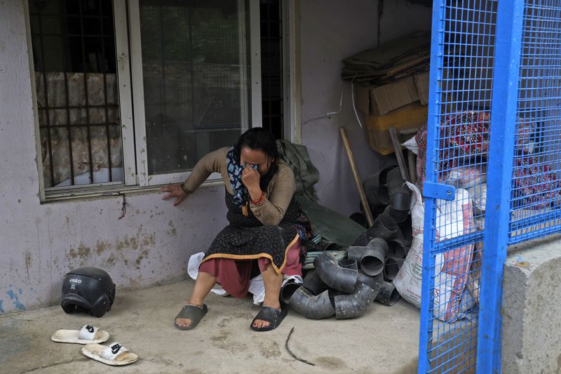 A woman cries after she lost her home due to floods caused by heavy rains in Kathmandu, Nepal, Saturday, Sept. 28, 2024. (AP Photo/Gopen Rai)