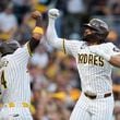 San Diego Padres' Fernando Tatis Jr., right, celebrates with Luis Arraez (4) after hitting a two-run home run during the first inning in Game 1 of an NL Wild Card Series baseball game against the Atlanta Braves, Tuesday, Oct. 1, 2024, in San Diego. (AP Photo/Gregory Bull)