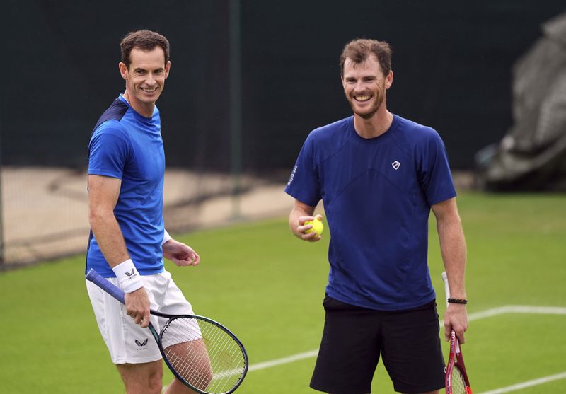 Andy Murray, left, and Jamie Murray stand on the practise courts on day two of the 2024 Wimbledon Championships at the All England Lawn Tennis and Croquet Club, London, Tuesday July 2, 2024. (Jordan Pettitt/PA via AP)