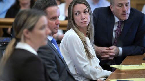 Karen Read, center, listens as the prosecutor questions Dr. Marie Russell, during Read's trial in Norfolk Superior Court, Friday, June 21, 2024, in Dedham, Mass. Read, 44, is accused of running into her Boston police officer boyfriend with her SUV in the middle of a nor'easter and leaving him for dead after a night of heavy drinking. (AP Photo/Josh Reynolds, Pool)