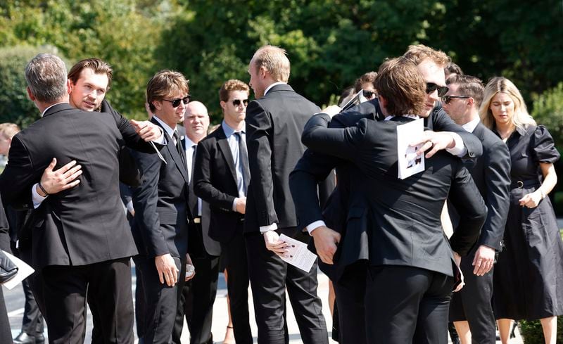 Players from the Columbus Blue Jackets and hockey players embrace after funeral for Columbus Blue Jackets hockey player John Gaudreau and brother Matthew Gaudreau at Saint Mary Magdalen Church in Media, Pa., Monday, Sept. 9, 2024. (Yong Kim/The Philadelphia Inquirer via AP)