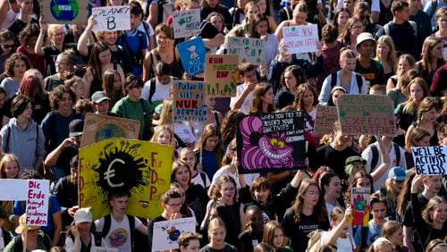 Students hold placards as they take part in a Global Climate Strike protest, part of the Fridays For Future movement, near the chancellery in Berlin, Germany, Friday, Sept. 20, 2024. (AP Photo/Markus Schreiber)