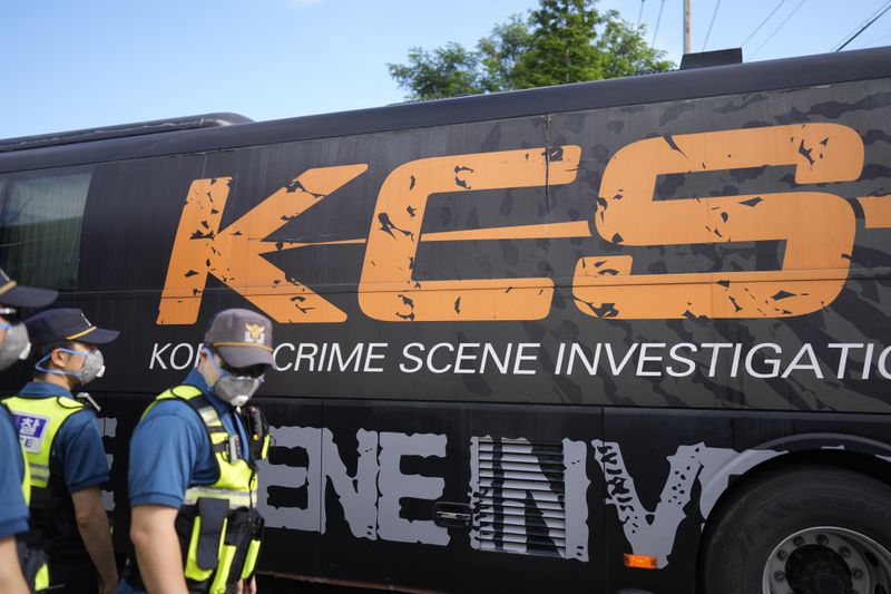 A vehicle of the South Korea Crime Scene Investigation team arrives outside of the site of a burnt battery manufacturing factory in Hwaseong, South Korea, Tuesday, June 25, 2024. (AP Photo/Lee Jin-man)