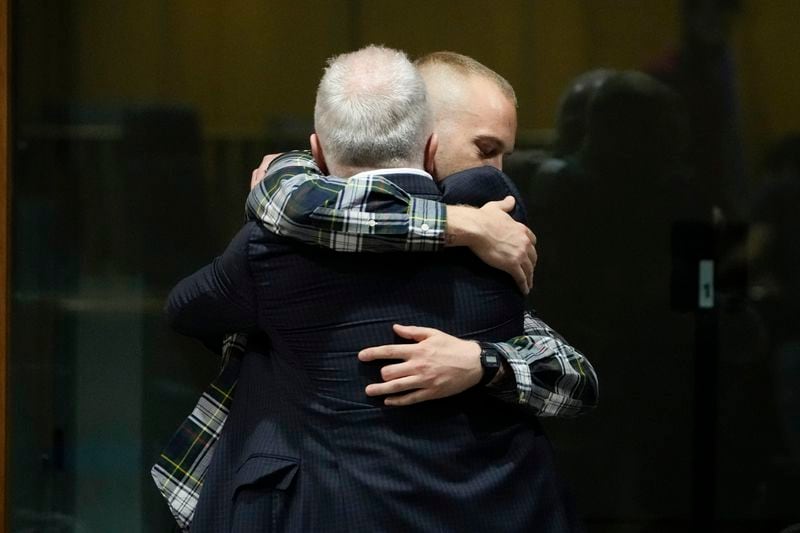 Ethan Elder, left, father of Finnegan Lee Elder hugs his son before the reading of the judgment at the end of a hearing for the appeals trial in which Finnegan is facing murder charges for killing Italian Carabinieri paramilitary police officer Mario Cerciello Rega, in Rome, Wednesday, July 3, 2024. (AP Photo/Alessandra Tarantino)