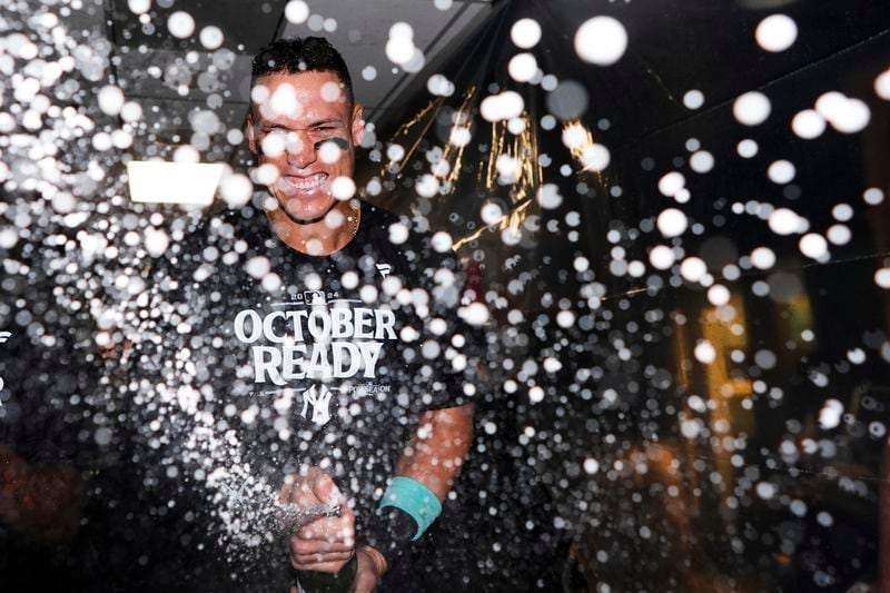 New York Yankees' Aaron Judge celebrates clinching a playoff spot after a 2-1 win in 10 innings over the Seattle Mariners in a baseball game Wednesday, Sept. 18, 2024, in Seattle. (AP Photo/Lindsey Wasson)