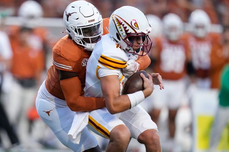 Texas linebacker Anthony Hill Jr. (0) sacks Louisiana-Monroe quarterback General Booty (14) during the first half of an NCAA college football game in Austin, Texas, Saturday, Sept. 21, 2024. (AP Photo/Eric Gay)