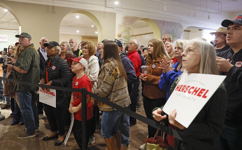 Voters listen as as Republican U.S. Senate candidate Herschel Walker speaks Monday in Rome. North Georgia could be the most conservative part of the state, so Walker, with the election only two weeks away, is spending three days campaigning there. (Natrice Miller/natrice.miller@ajc.com)  