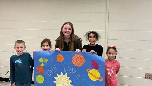 HIgh school senior Tess Sheheane (center) created the DHH Lunch Bunch, a program for Cobb County with deafness or hearing loss.