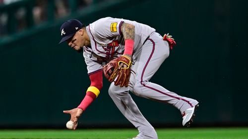 Orlando Arcia fields a ball hit by J.T. Realmuto barehanded during the fifth inning of a baseball game, Sunday, Sept. 1, 2024, in Philadelphia. (AP Photo/Derik Hamilton)