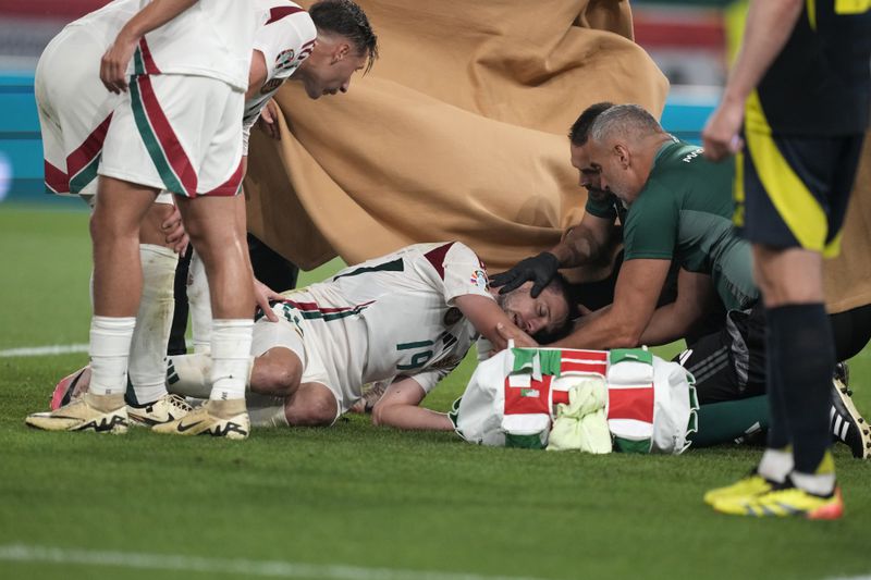 Hungary's Barnabas Varga is injured during a Group A match between Scotland and Hungary at the Euro 2024 soccer tournament in Stuttgart, Germany, Sunday, June 23, 2024. (AP Photo/Antonio Calanni)