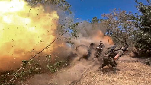 In this photo taken from a video released by the Russian Defense Ministry on Thursday, Aug. 22, 2024, a Russian soldier fires from D-30 howitzer towards Ukrainian positions in an undisclosed location in Ukraine. (Russian Defense Ministry Press Service via AP)