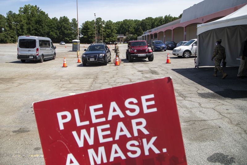 08/27/2020 - Doraville, Georgia -  Signs displayed ask patients to wear a mask while being tested at a DeKlab County Board of Health drive-thru COVID-19 testing site in the parking lot of a closed K-Mart in Doraville, Thursday, August 27, 2020. (ALYSSA POINTER / ALYSSA.POINTER@AJC.COM)