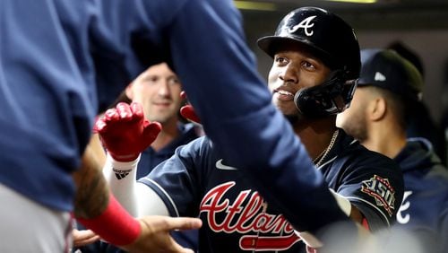 Braves designated hitter Jorge Soler celebrates his leadoff home run against the Houston Astros with teammates in the dugout in Game 1 of the World Series Tuesday, Oct. 26, 2021, at Minute Maid Park in Houston. (Curtis Compton / curtis.compton@ajc.com)