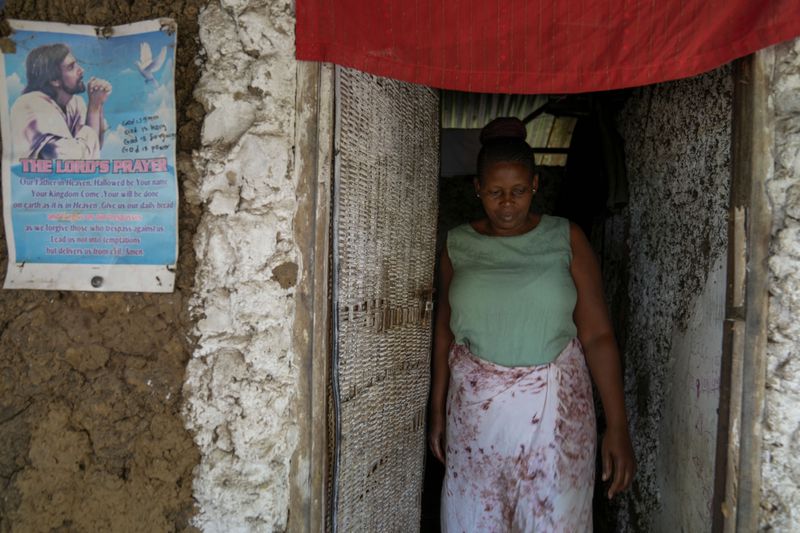 Priscillar Riziki, whose daughter and three grandchildren are believed to have been among the victims of the Good News International Church cult, walks out of her house in the coastal city of Malindi, in southern Kenya, on Saturday, Sept. 7, 2024. (AP Photo/Brian Inganga)