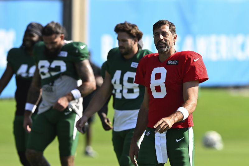 New York Jets quarterback Aaron Rodgers (8) looks on during an NFL football joint practice with the Carolina Panthers Thursday, Aug. 15, 2024, in Charlotte, N.C. (AP Photo/Matt Kelley)