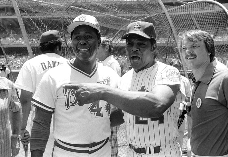 Willie Mays, right, batting great of the Giants and Mets, gets together with home run record hitter Hank Aaron of the Atlanta Braves, during Old timers Day festivities at Dodger Stadium on Sunday, July 6, 1980 in Los Angeles. (AP Photo)