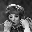 FILE - Make up and hair artists add the finishing touches to British actress Maggie Smith before she faces the camera with Peter Ustinov in the comedy 'Hot Millions' being filmed at Elstree Studios, England, Jan. 12, 1968. Smith has died aged 89. (AP Photo/Bob Dear, File)