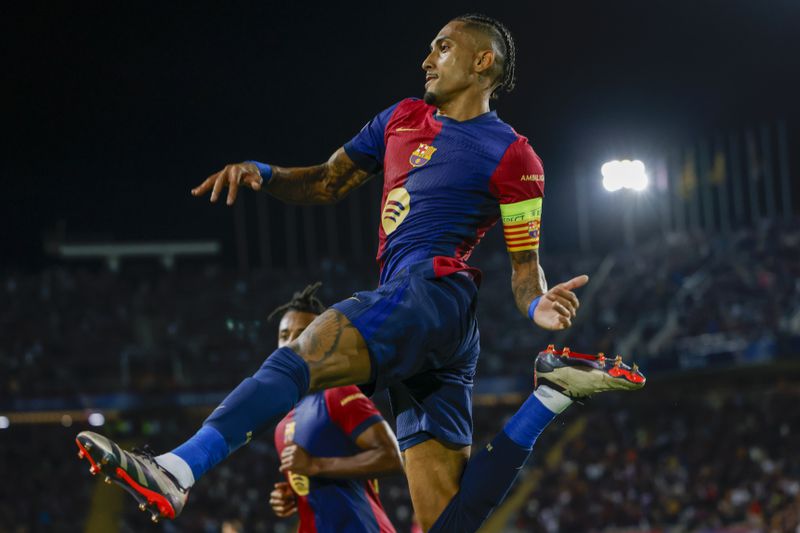 Barcelona's Raphinha celebrates after scoring his side's second goal during the Champions League soccer match between Barcelona and Young Boys at the Lluis Companys Olympic Stadium in Barcelona, Spain, Tuesday, Oct. 1, 2024. (AP Photo/Joan Monfort)