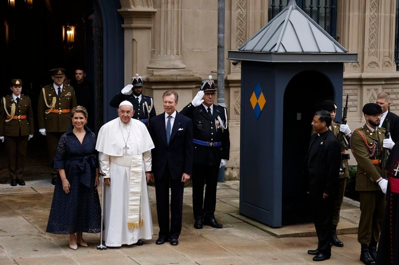 Pope Francis is welcomed by Grand Duchess Maria Teresa, left, and Luxembourg's Grand Duke Henri, right, at the Grand Ducal Palace in Luxembourg, Thursday, Sept. 26, 2024. (AP Photo/Omar Havana)