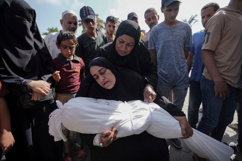 A woman holds the body of her daughter Zena Naser, killed in an Israeli bombardment on a residential building in Maghazi refugee camp, outside the morgue of al-Aqsa Martyrs Hospital in Deir al Balah, central Gaza Strip, Tuesday, June 25, 2024. (AP Photo/Abdel Kareem Hana)