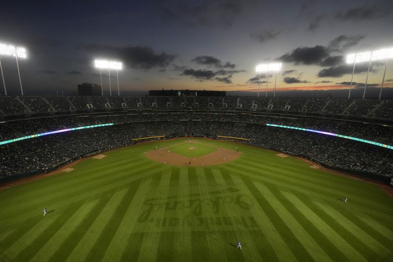 Fans at the Oakland Coliseum watch during the second inning of a baseball game between the Oakland Athletics and the Texas Rangers in Oakland, Calif., Wednesday, Sept. 25, 2024. (AP Photo/Jeff Chiu)