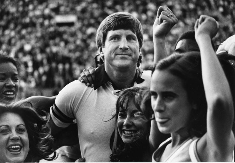 Georgia Tech coach Bill Curry celebrating tie against Notre Dame with Tech cheerleaders. Photo taken Nov. 8, 1980. (Bill Mahan/AJC staff)