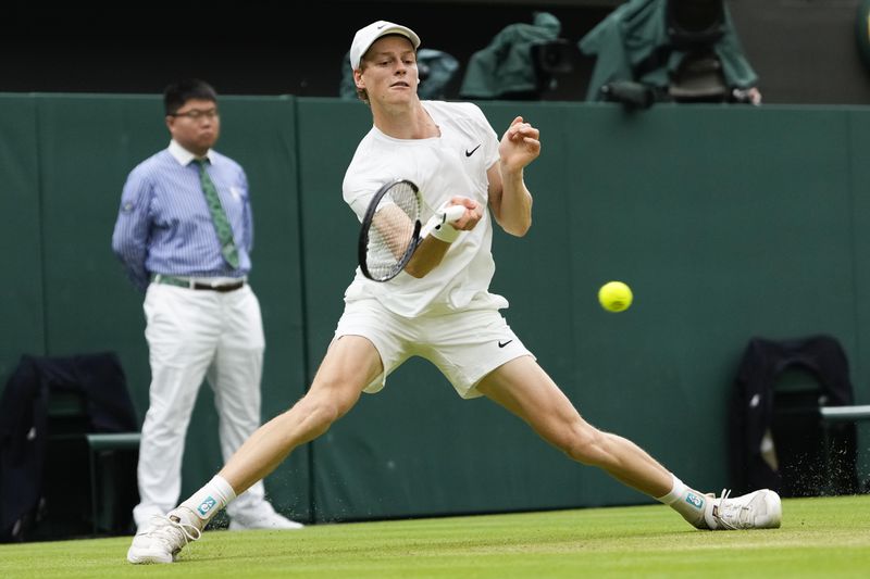 Jannik Sinner of Italy plays a forehand return to Daniil Medvedev of Russia during their quarterfinal match at the Wimbledon tennis championships in London, Tuesday, July 9, 2024. (AP Photo/Alberto Pezzali)