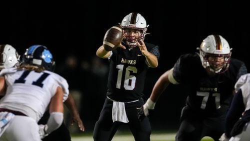 Shane Throgmartin (16) of Mill Creek receives that snap during a game between Camden County vs. Mill Creek on Friday, Nov. 24, 2023.  (Jason Allen for the Atlanta Journal Constitution)