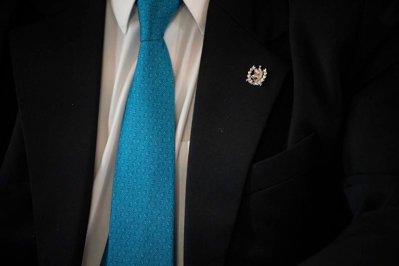 A pin with the Guatemalan coat of arms hangs on President Bernardo Arevalo's coat as he gives an interview at the National Palace in Guatemala City, Thursday, June 20, 2024. (AP Photo/Santiago Billy)
