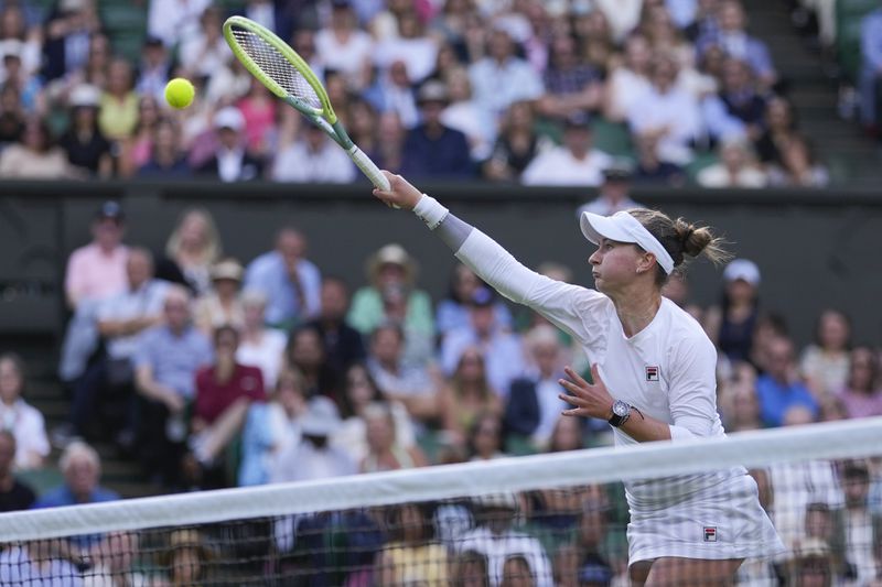 Barbora Krejcikova of the Czech Republic plays a forehand return to Elena Rybakina of Kazakhstan during their semifinal match at the Wimbledon tennis championships in London, Thursday, July 11, 2024. (AP Photo/Alberto Pezzali)