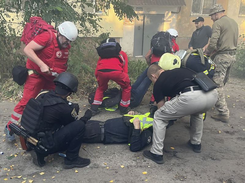 In this photo provided by the Ukrainian Emergency Service, paramedics give first aid to injured Emergency Service workers after Russian attacks on a medical center in the northeastern Ukrainian city of Sumy Saturday, Sept. 28, 2024. (Ukrainian Emergency Service via AP)