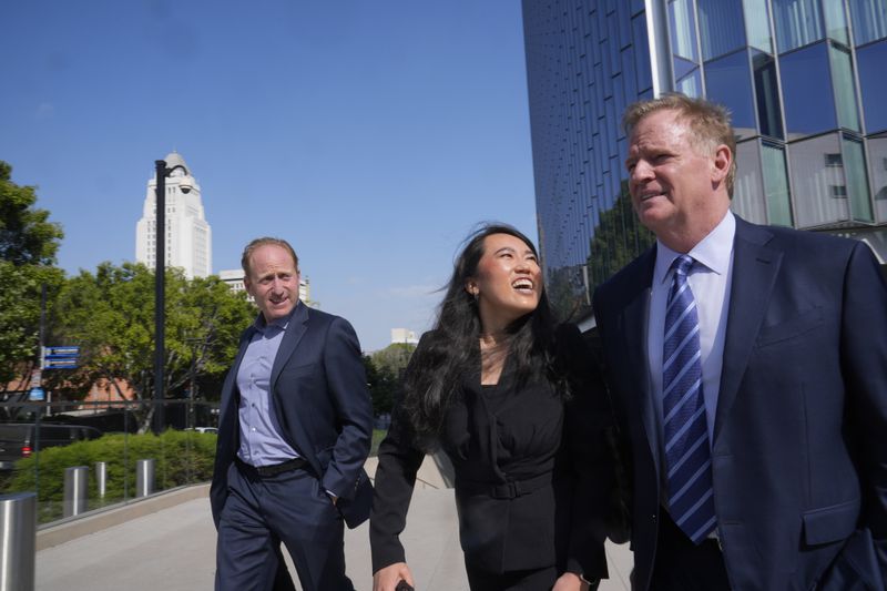 NFL Commissioner Roger Goodell, right, leaves at federal court Monday, June 17, 2024, in Los Angeles. Goodell reiterated during testimony in federal court Monday that the league's "Sunday Ticket" package, the subject of a class-action lawsuit, is a premium product while also defending the league's broadcast model. (AP Photo/Damian Dovarganes)