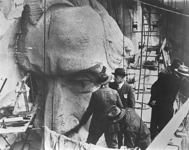 Sculptor Augustus Lukeman (hand on sculpture) inspects the head of Robert E. Lee in this 1928 photograph. Lukeman, who began work on the carving in 1926, was the second sculptor to work on the project. His design formed the basis of the sculpture completed this spring. Gutzon Borglum began work on the mountain in 1923 but left in 1925. His beginning efforts were removed from the mountain. (FILE PHOTO)