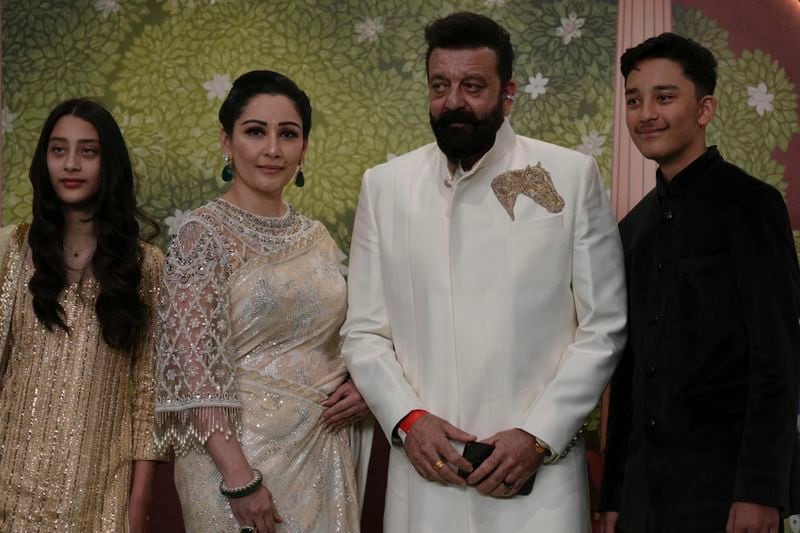 Indian actor Sanjay Dutt, second right, along with his family pose for a picture during the blessing ceremony of newlywed couple Anant Ambani son of billionaire Mukesh Ambani's and his wife Radhika Merchant at Jio World Convention Centre in Mumbai, India, Saturday, July. 13, 2024. (AP Photo /Rajanish Kakade)